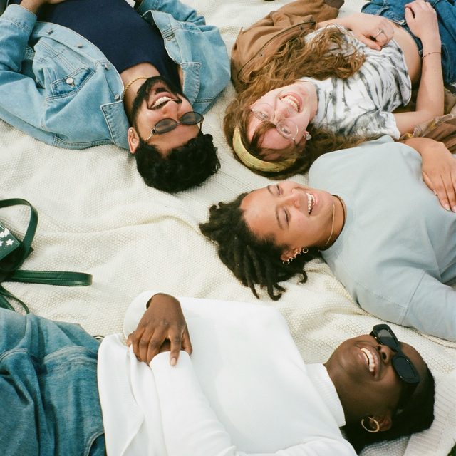 Friends on a blanket in the grass