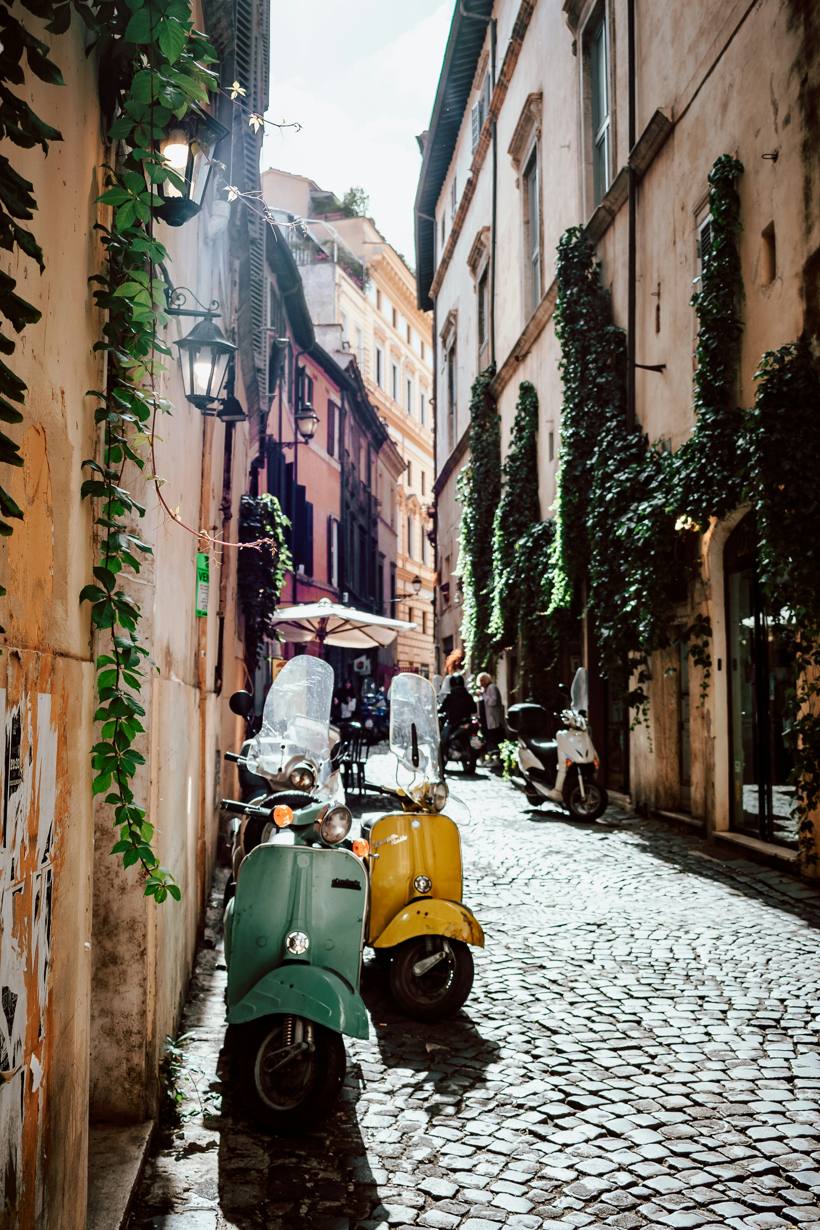 A quiet Trastevere alley with parked Vespas